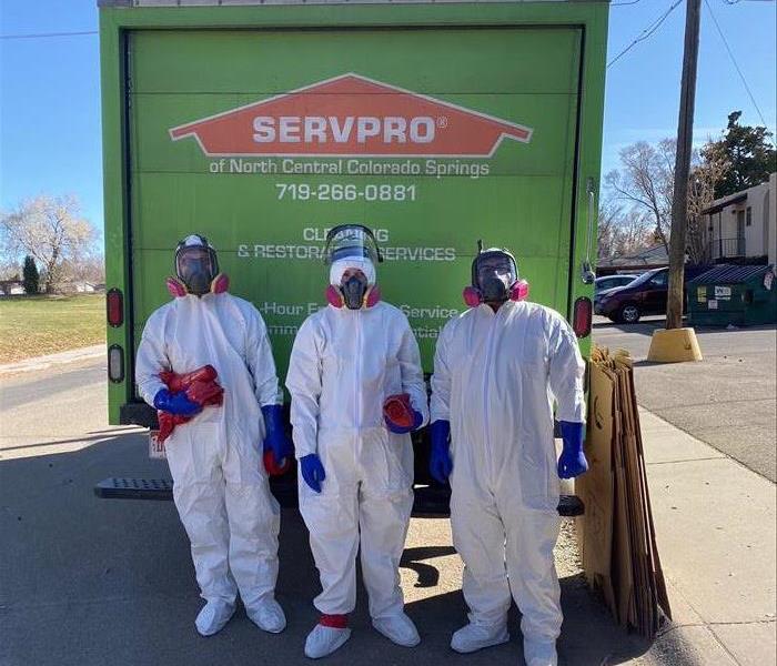 3 team members in front of SERVPRO truck.