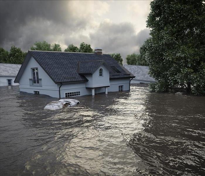 Image of a flooded neighborhood. A house is underwater.